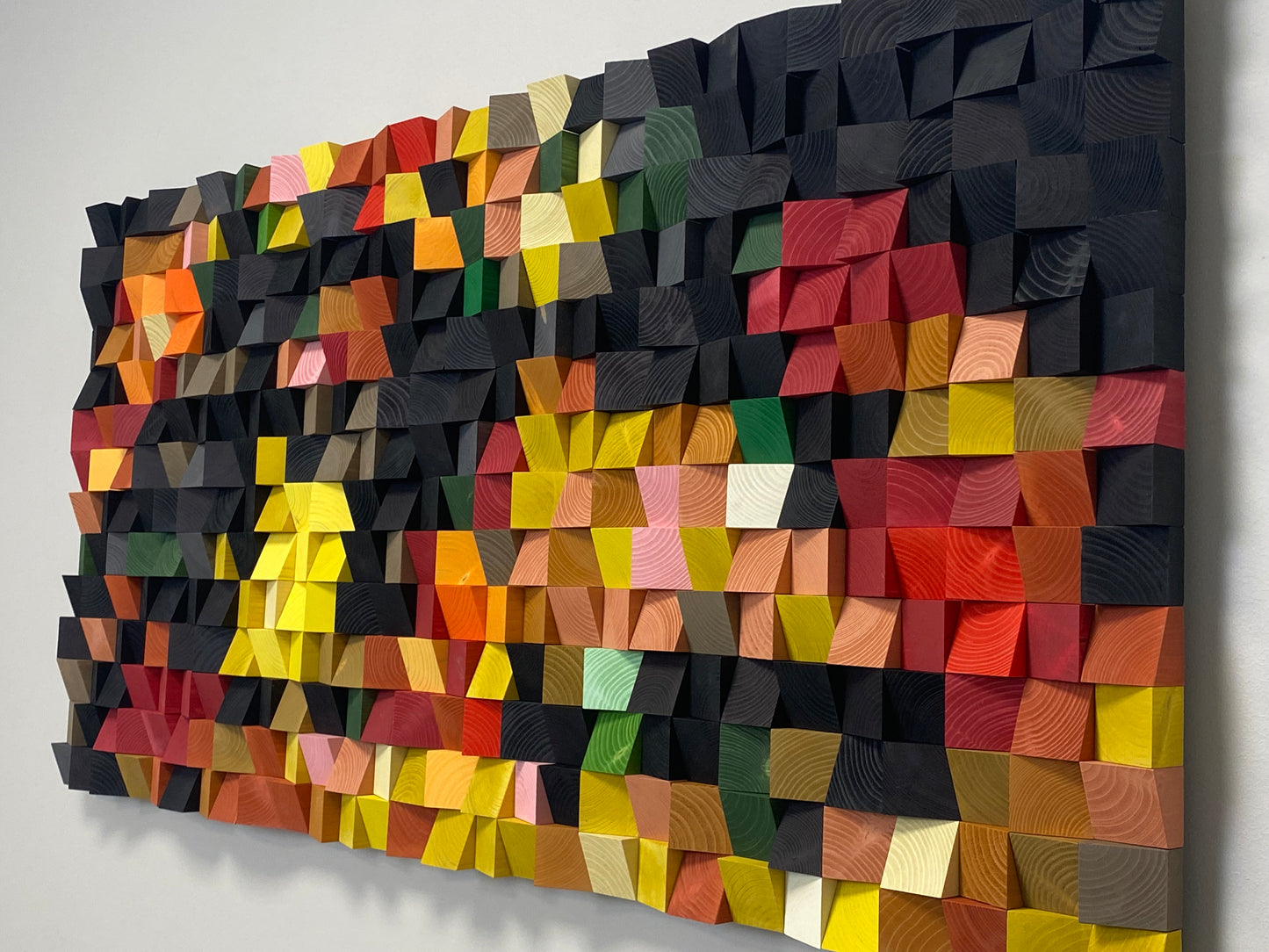 Acoustic wall panel in rich natural wood shades combined with bright fruit-inspired colors.