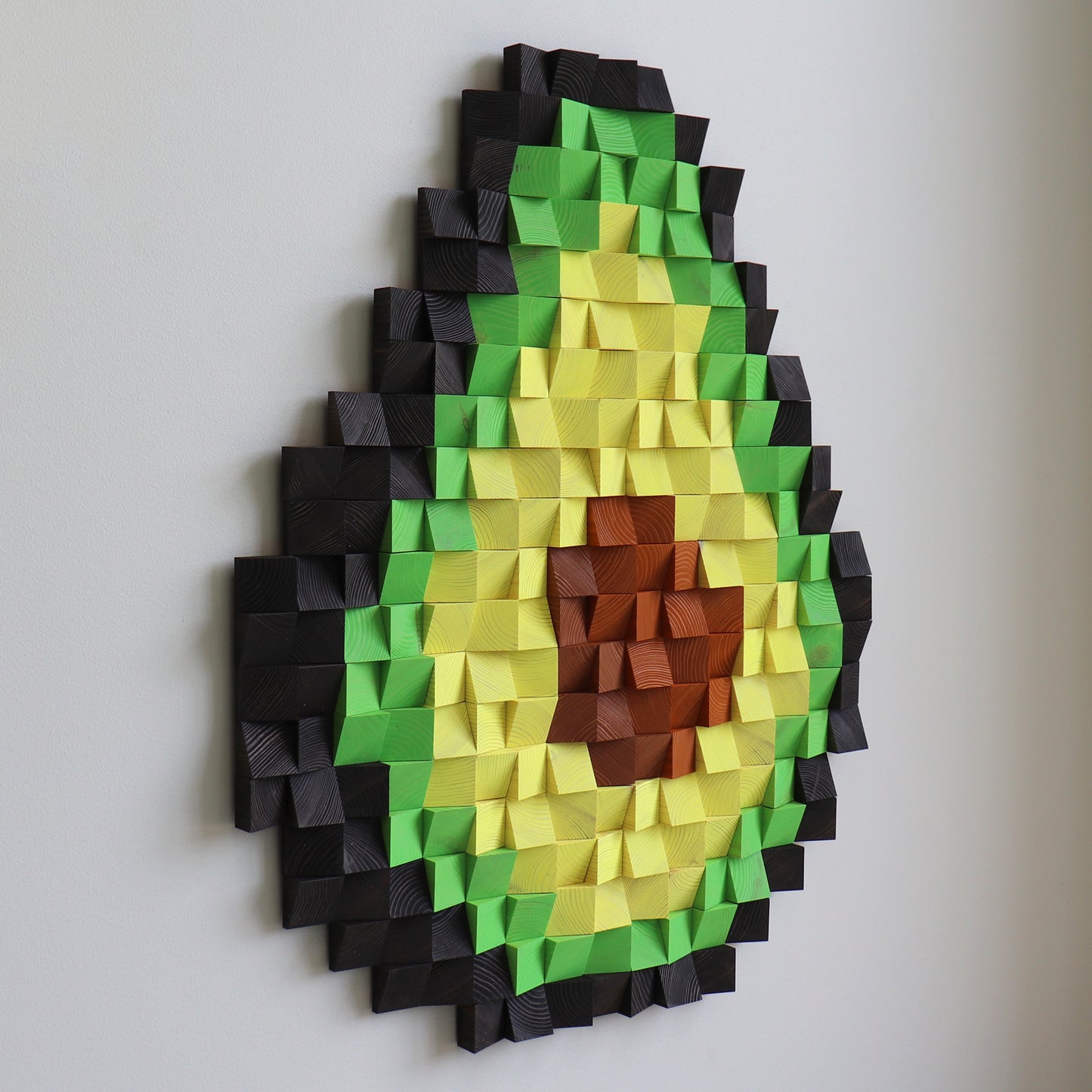 3D avocado wood panel art displayed in a modern interior, with layered textures and bold colors.