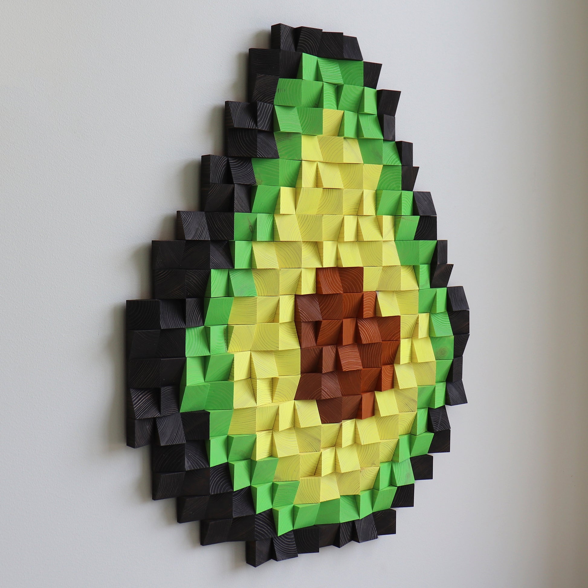 3D avocado wood panel art displayed in a modern interior, with layered textures and bold colors.