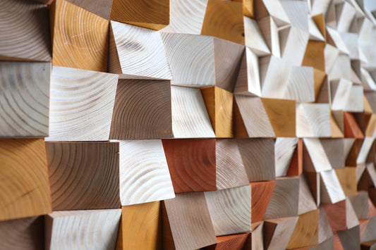 Left angle close up of handcrafted geometric wood wall panel with warm earth-tone gradient