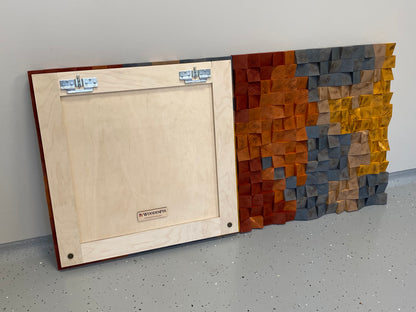 Artistic handcrafted wooden wall art featuring textured blocks and burnt finishes.