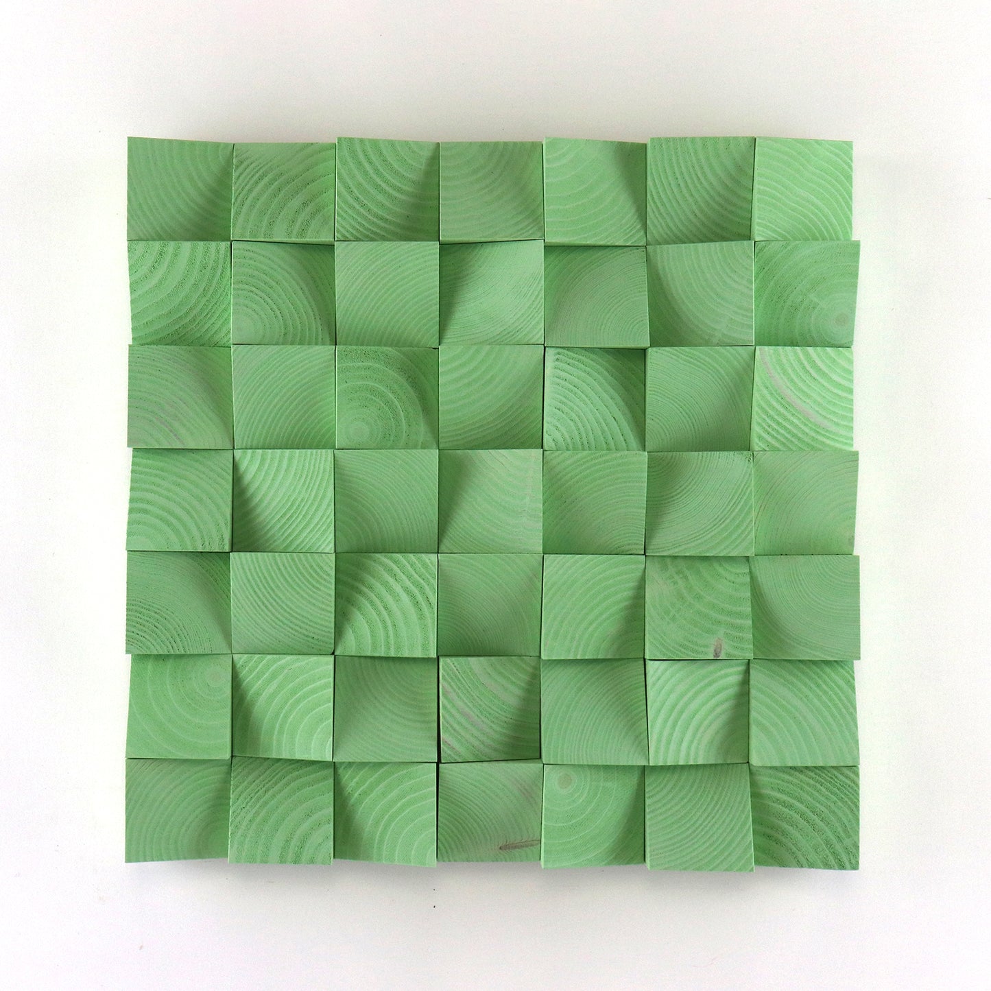 Handmade pastel green 3D wood wall art made from carved wooden blocks with geometric texture