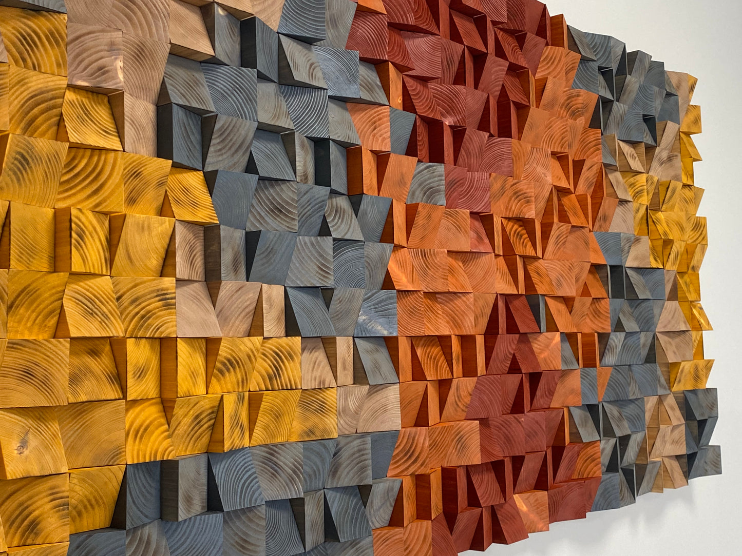 Rustic Burnt Wood Block Art showing a geometric pattern in warm amber and dark gray.