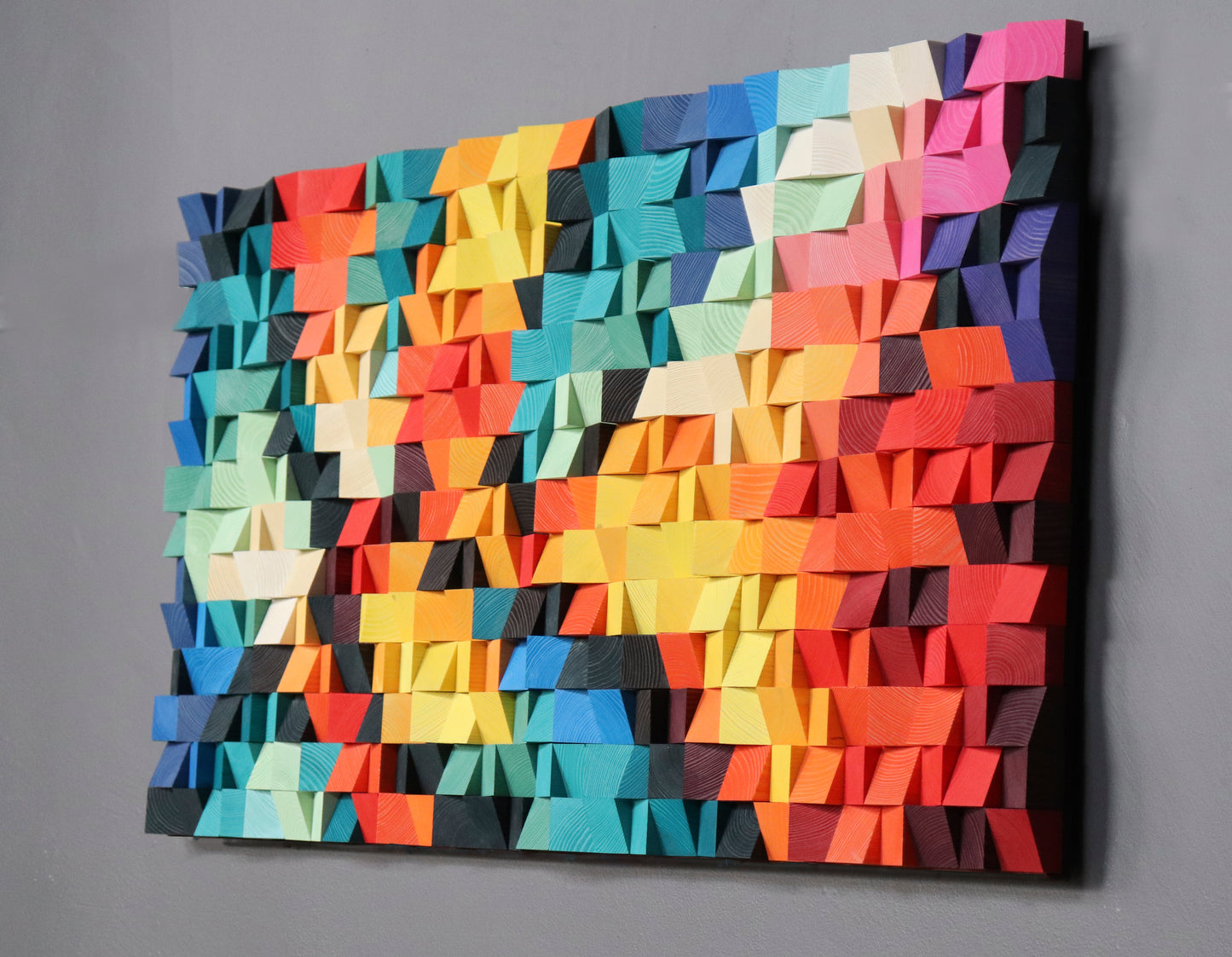 Handmade wooden wall panel showing natural wood grain and vivid painted surfaces.