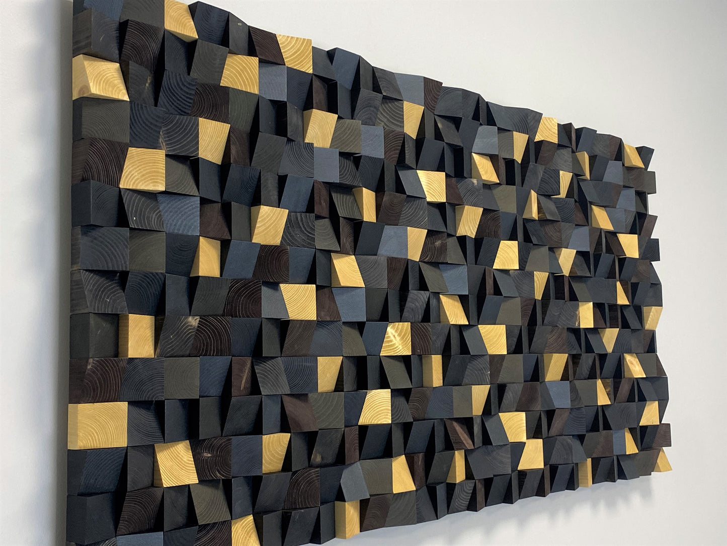 Elegant acoustic wooden wall panel with gold accents and dark geometric pattern.