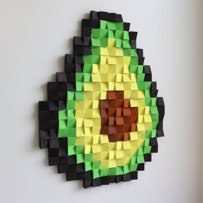 3D wooden avocado wall art made from carved wood blocks in green, yellow, and brown tones.
