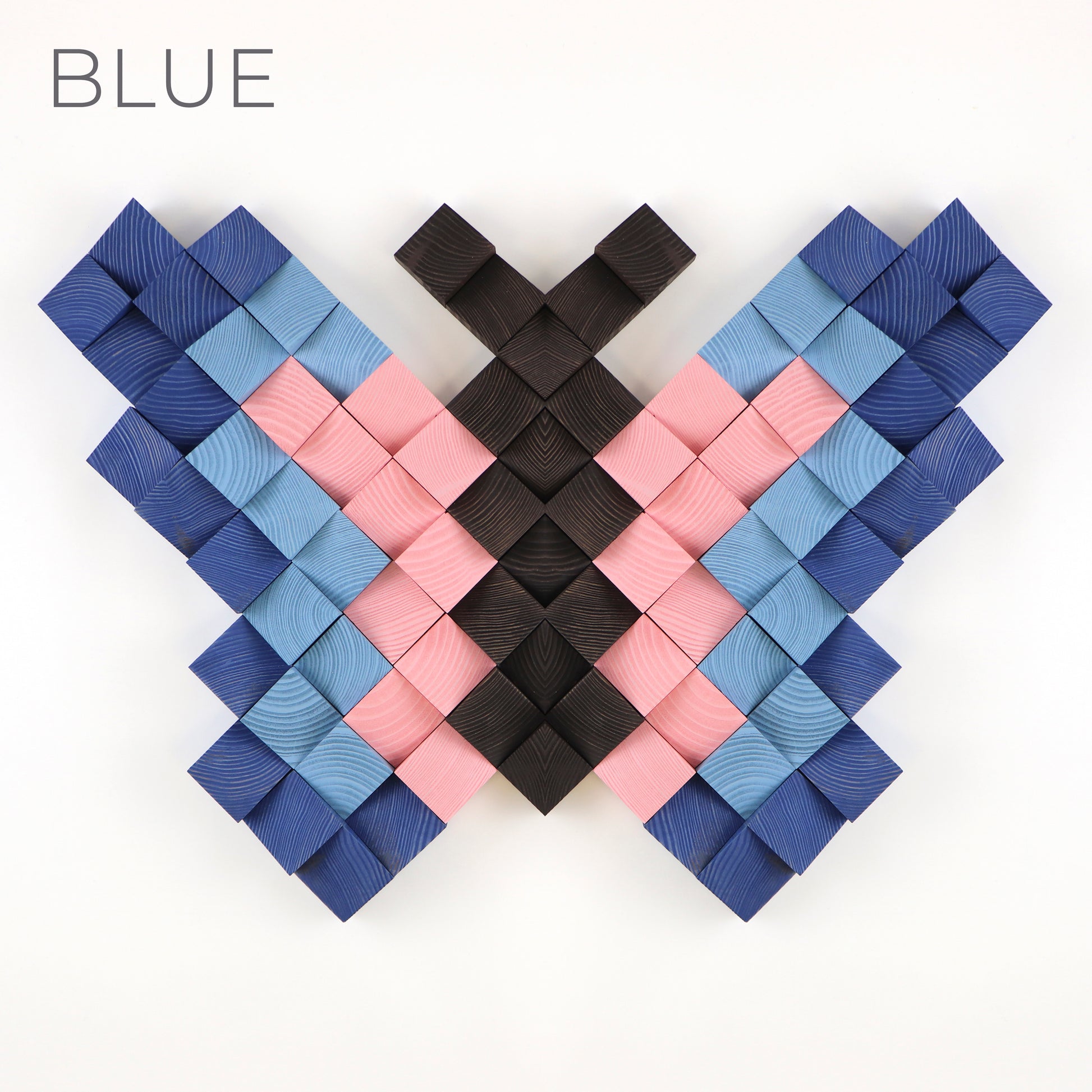 Blue and pink 3D wooden butterfly wall decor made from individually carved wooden blocks.