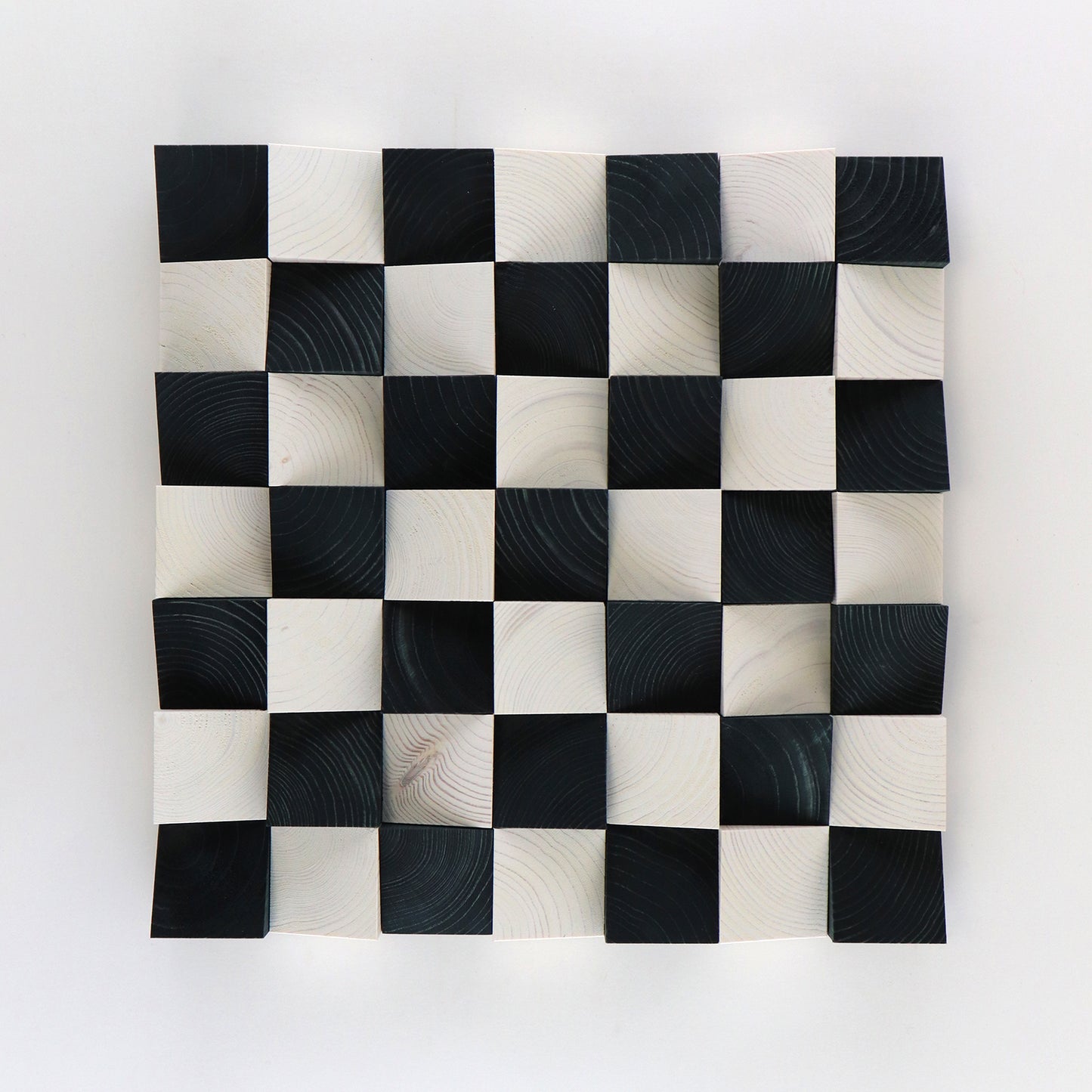 3D wooden checkerboard wall art panel featuring black and white handcrafted blocks.