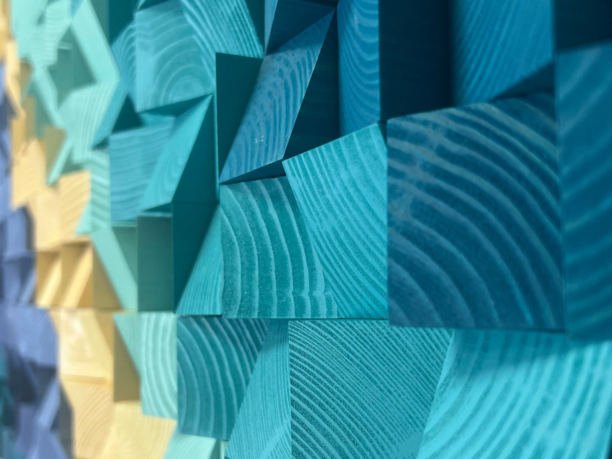 Detailed acoustic panel surface with layered wooden blocks in blue and sand colors.