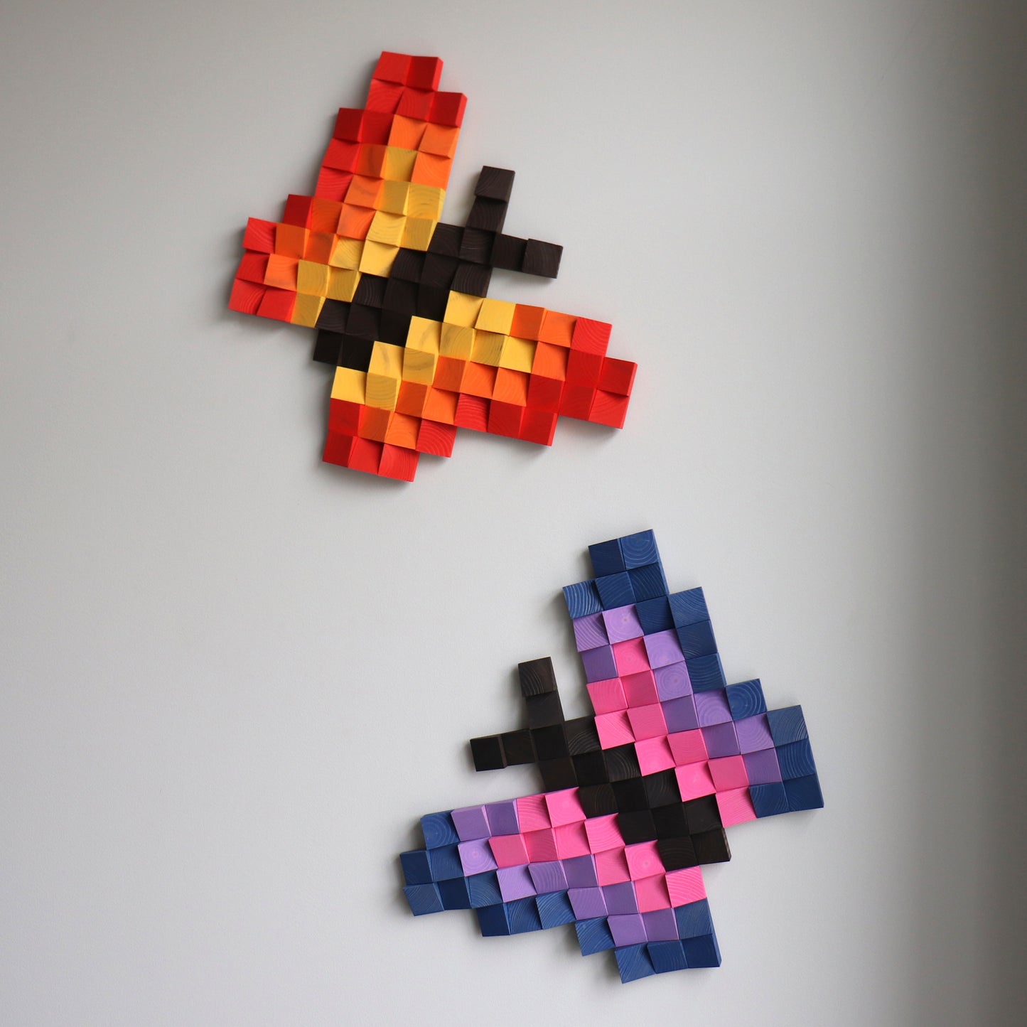 Set of colorful wooden butterfly wall art pieces displayed together on a wall.