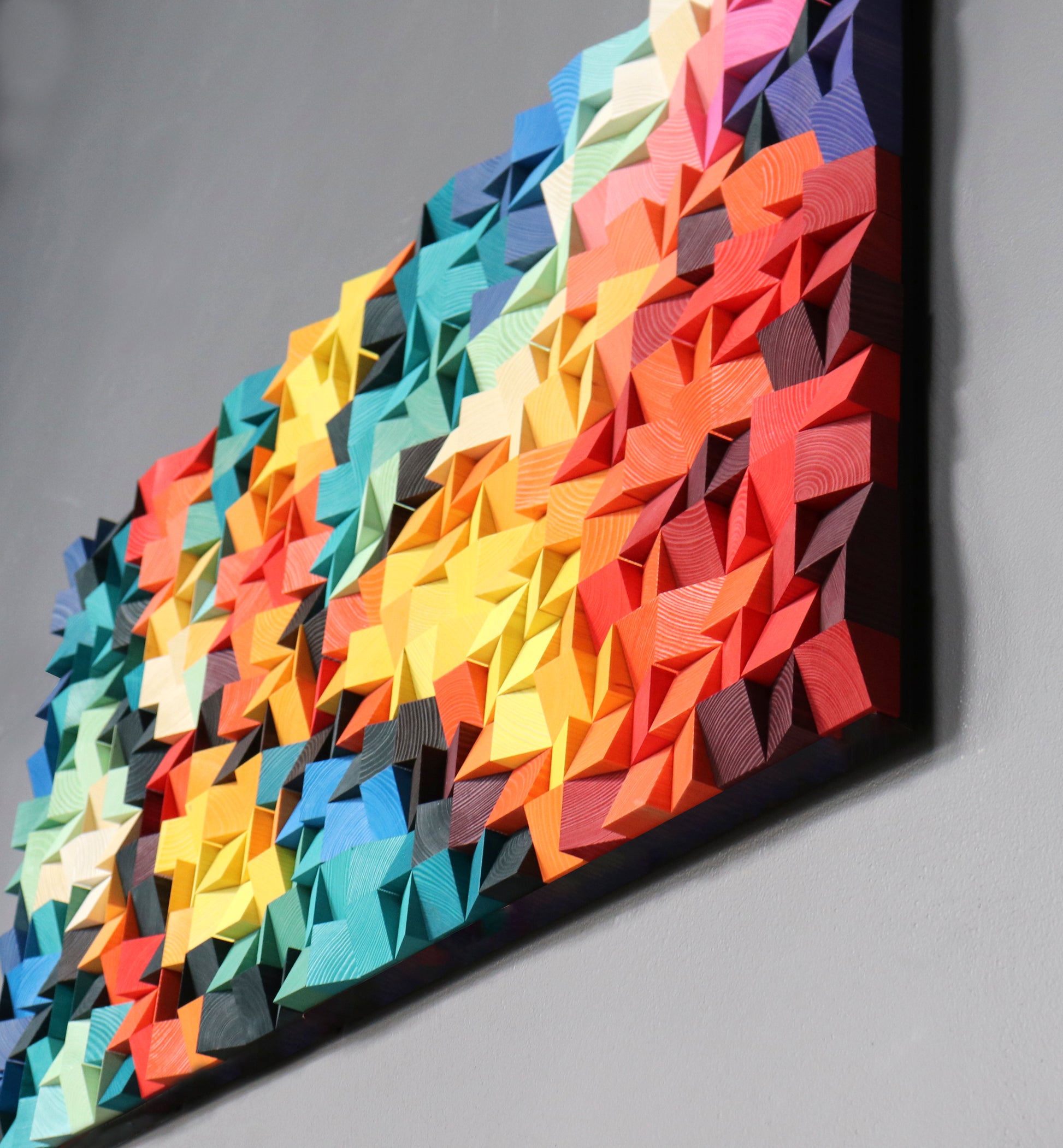 Handcrafted acoustic wooden wall panel with spring-inspired bright color gradient.