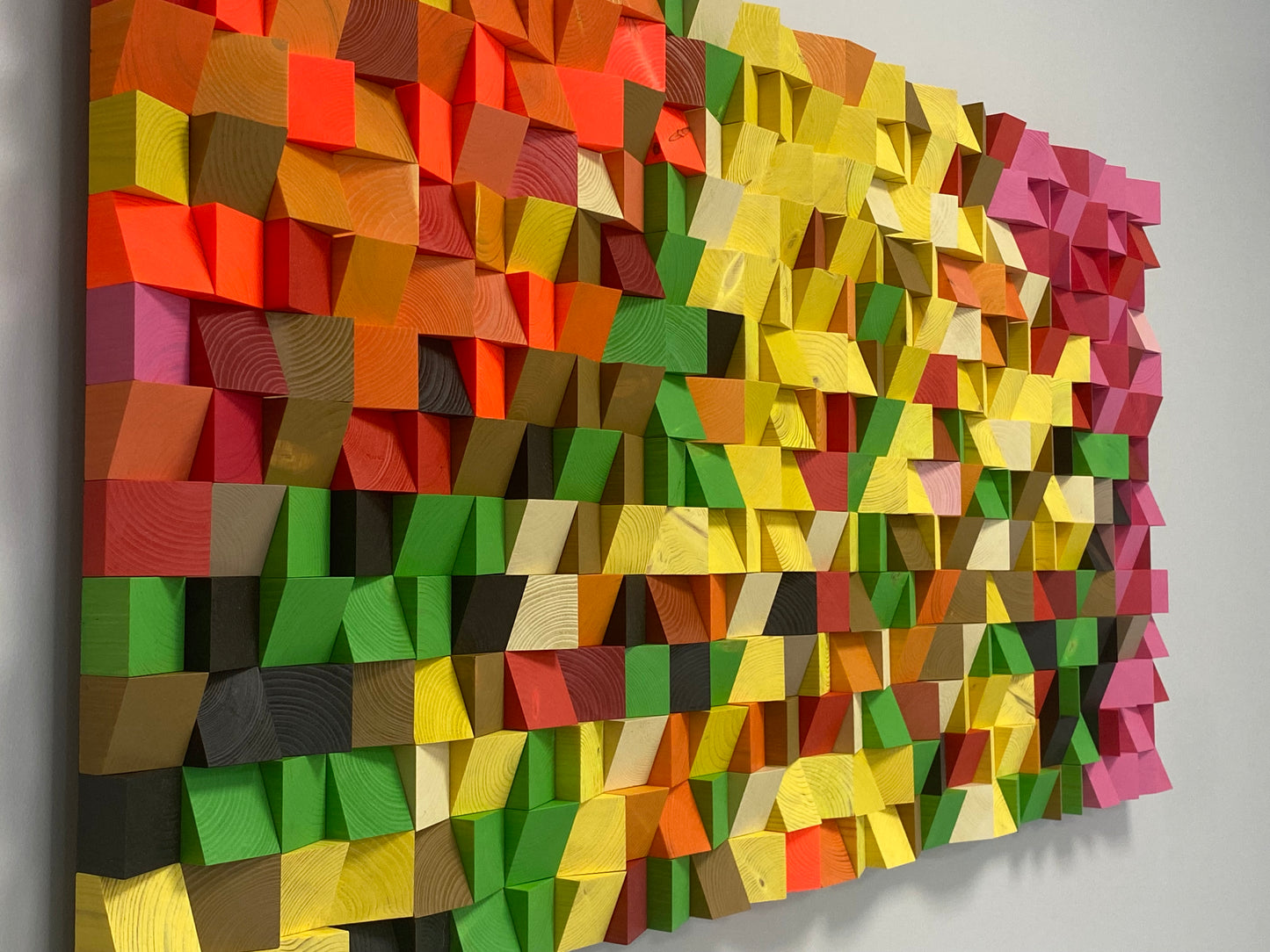 Colorful handcrafted acoustic panel by WoodenPix with neon tones and eco-friendly wooden blocks.