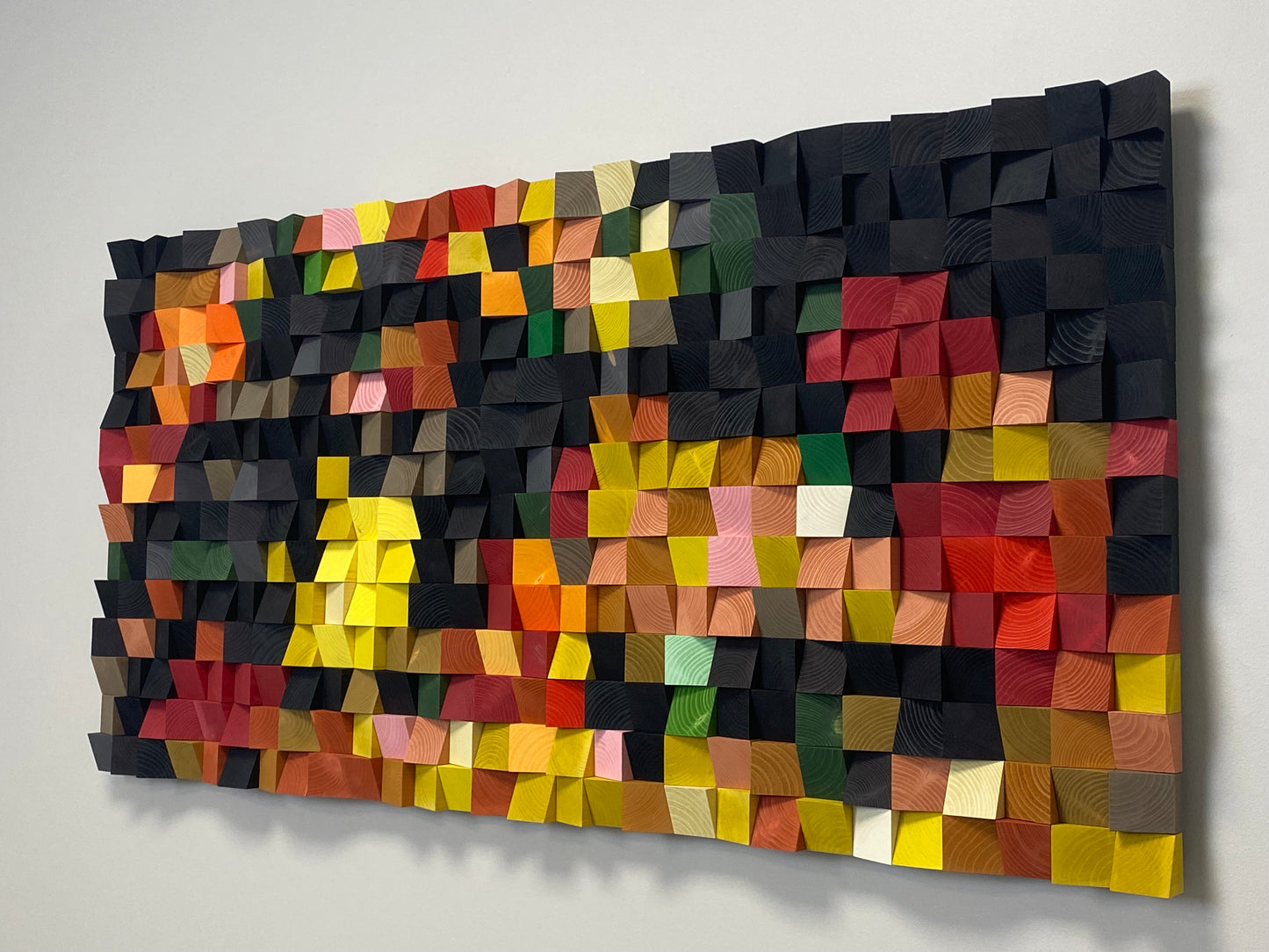 Artistic 3D wooden sound diffuser in a fruit color palette blending craftsmanship and color.