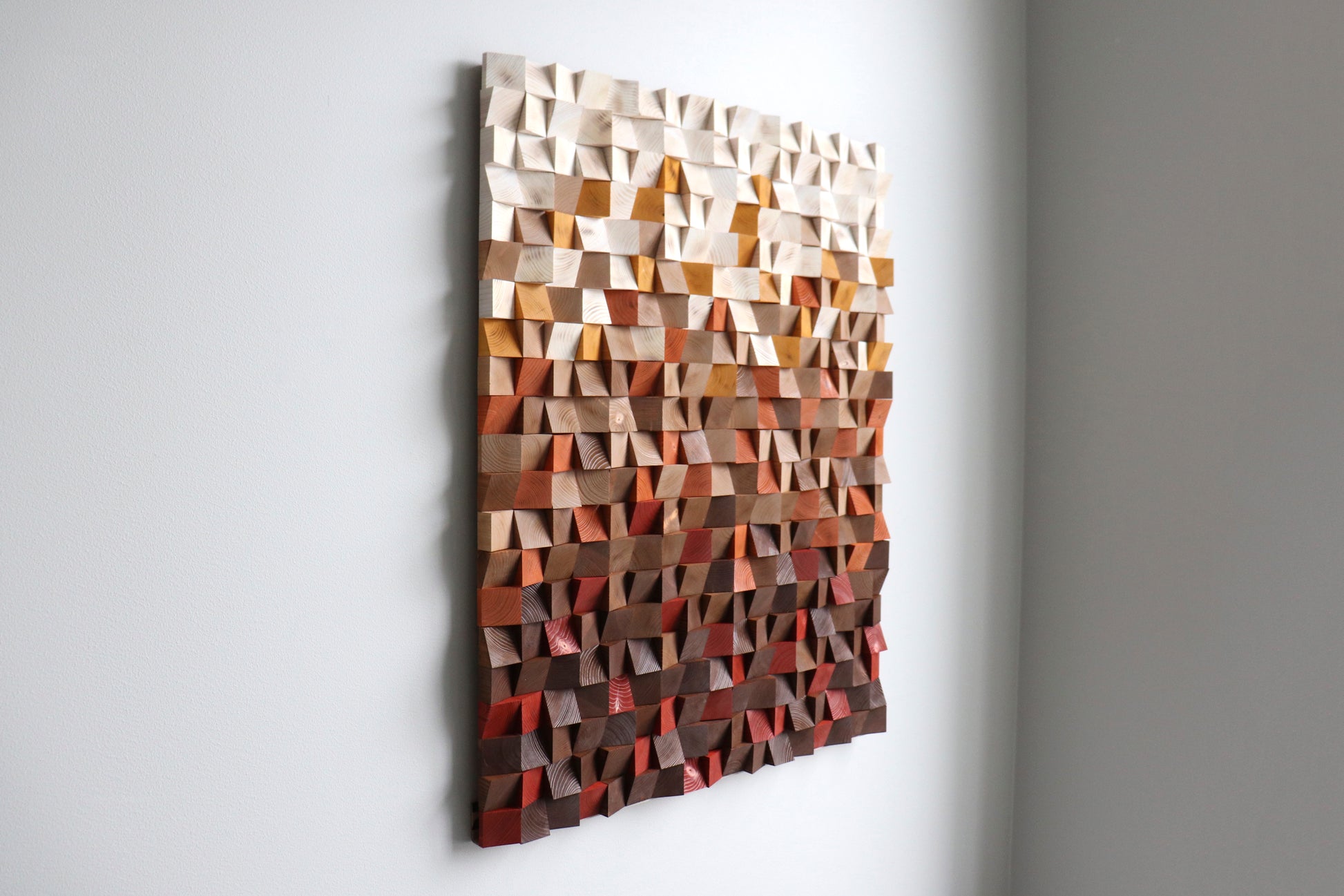 Room view of contemporary 3D wooden wall art in warm earth palette; interior styling example.