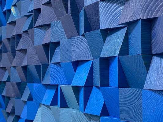 Ocean-inspired handcrafted wooden sound diffuser panel in multiple shades of blue.