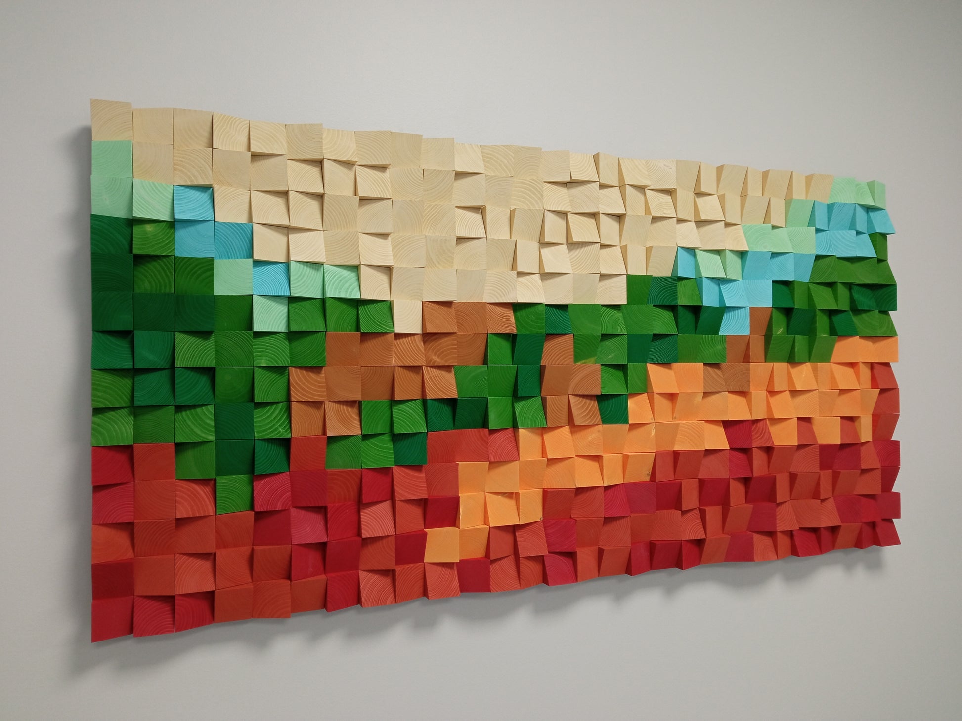 Vibrant fall-inspired wooden acoustic wall decor with textured geometric blocks.