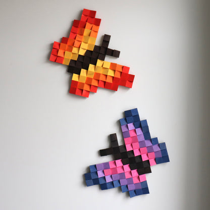 Detailed red and purple butterfly sculpture created from hand-shaped wooden blocks.