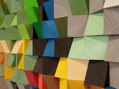 Handcrafted wooden wall art with meadow-like gradients in green, yellow, and natural wood shades.