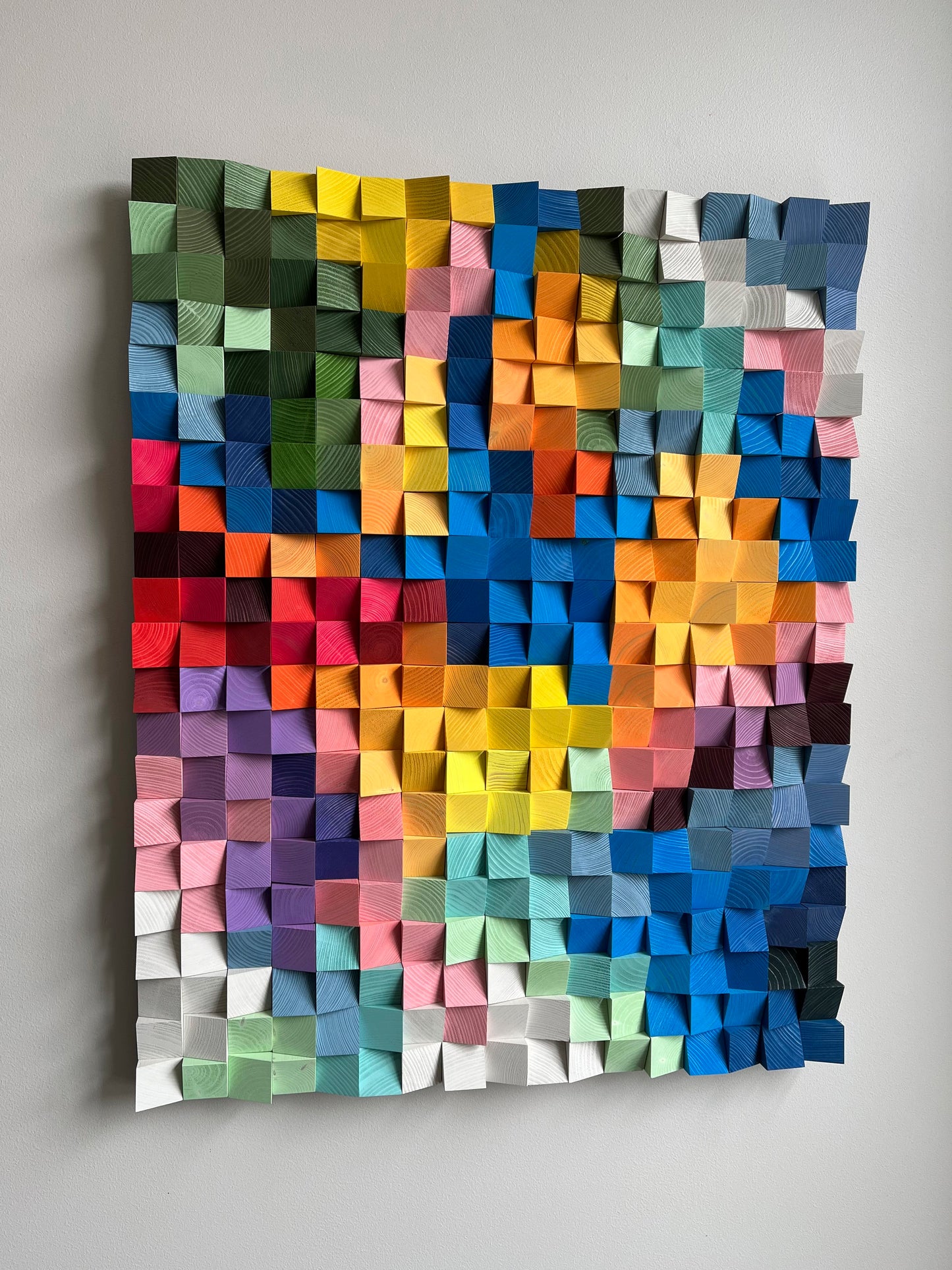 Artistic acoustic wall panel with rainbow palette handcrafted from natural wood.