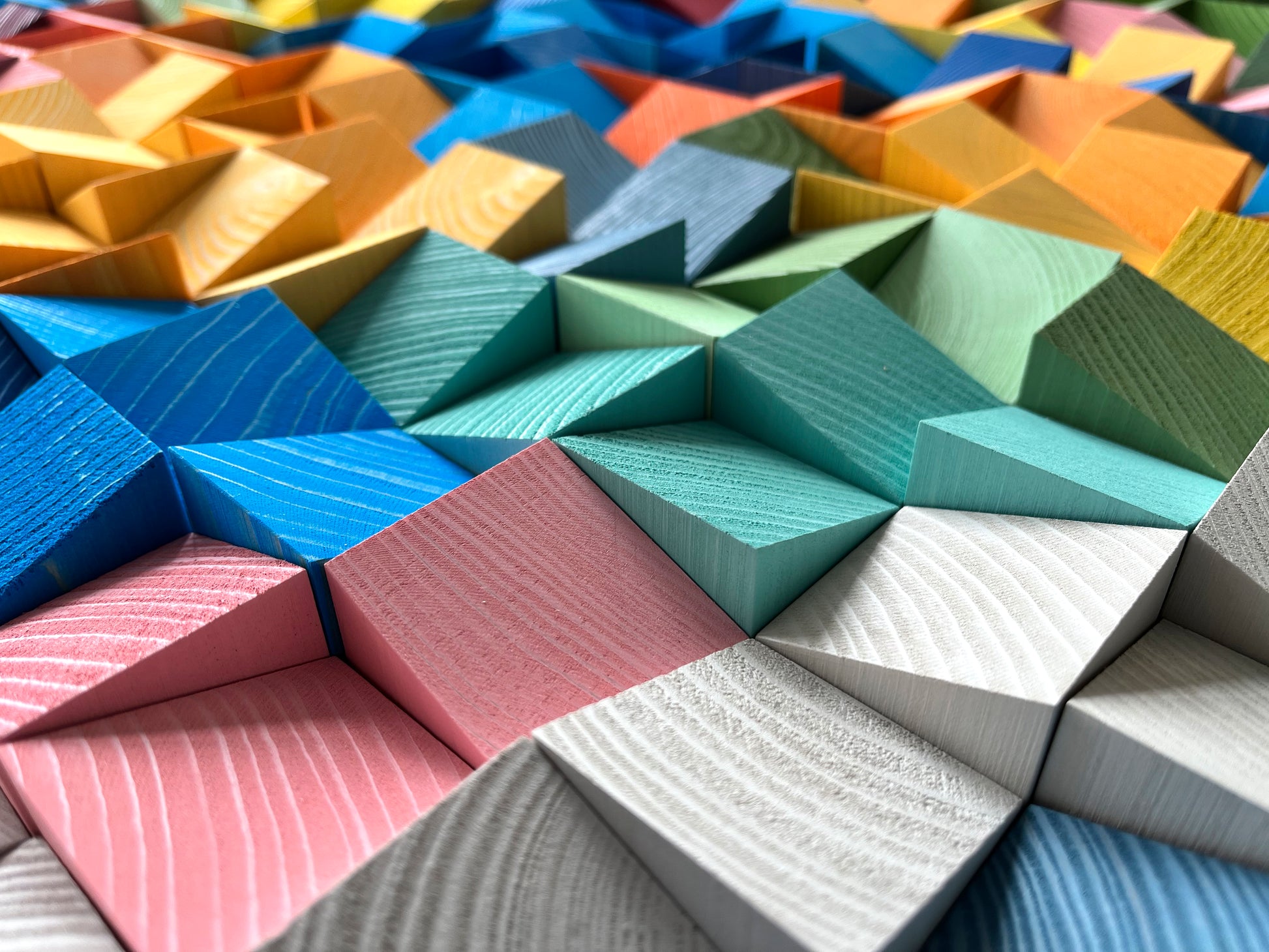 Rainbow-colored 3D wooden acoustic panel designed for modern interiors by WoodenPix.