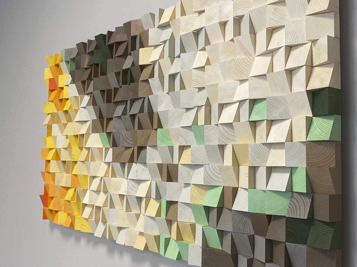 Modern wooden wall decor illustrating a sunlit mountain landscape in warm and cool tones.