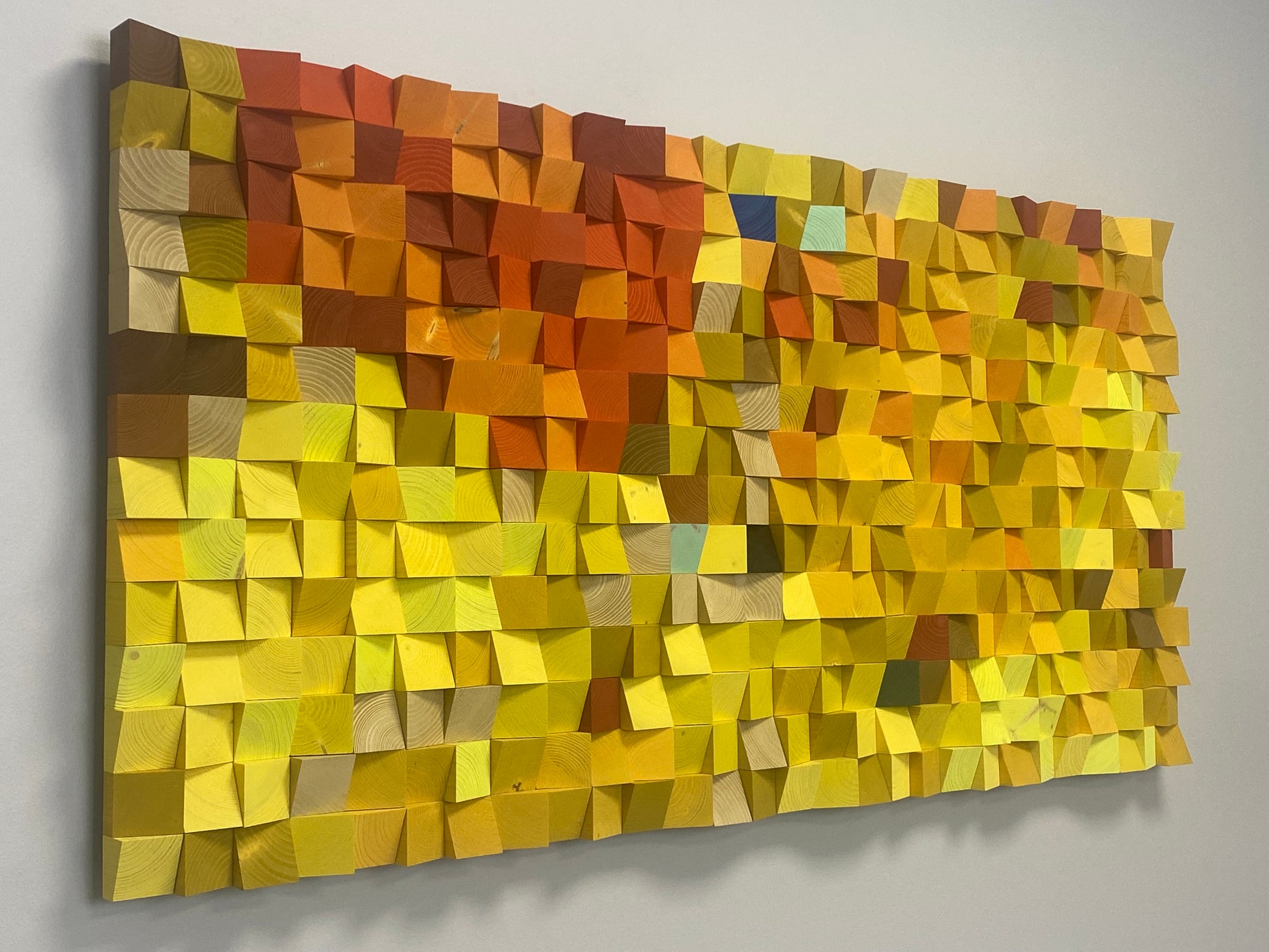 Handmade 3D wooden wall panel in yellow and orange hues designed for both decoration and sound balance.