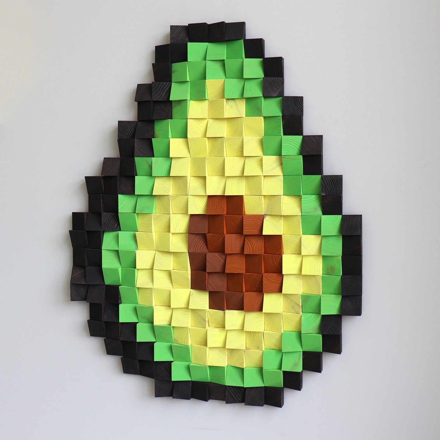 handmade wood block avocado art, highlighting the grid texture and vibrant colors.