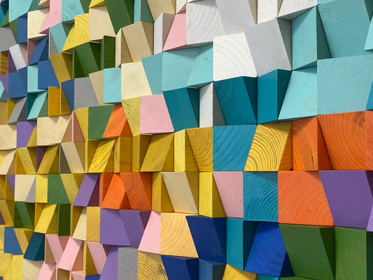 Handmade wooden mosaic panel featuring bright textured wood pieces.