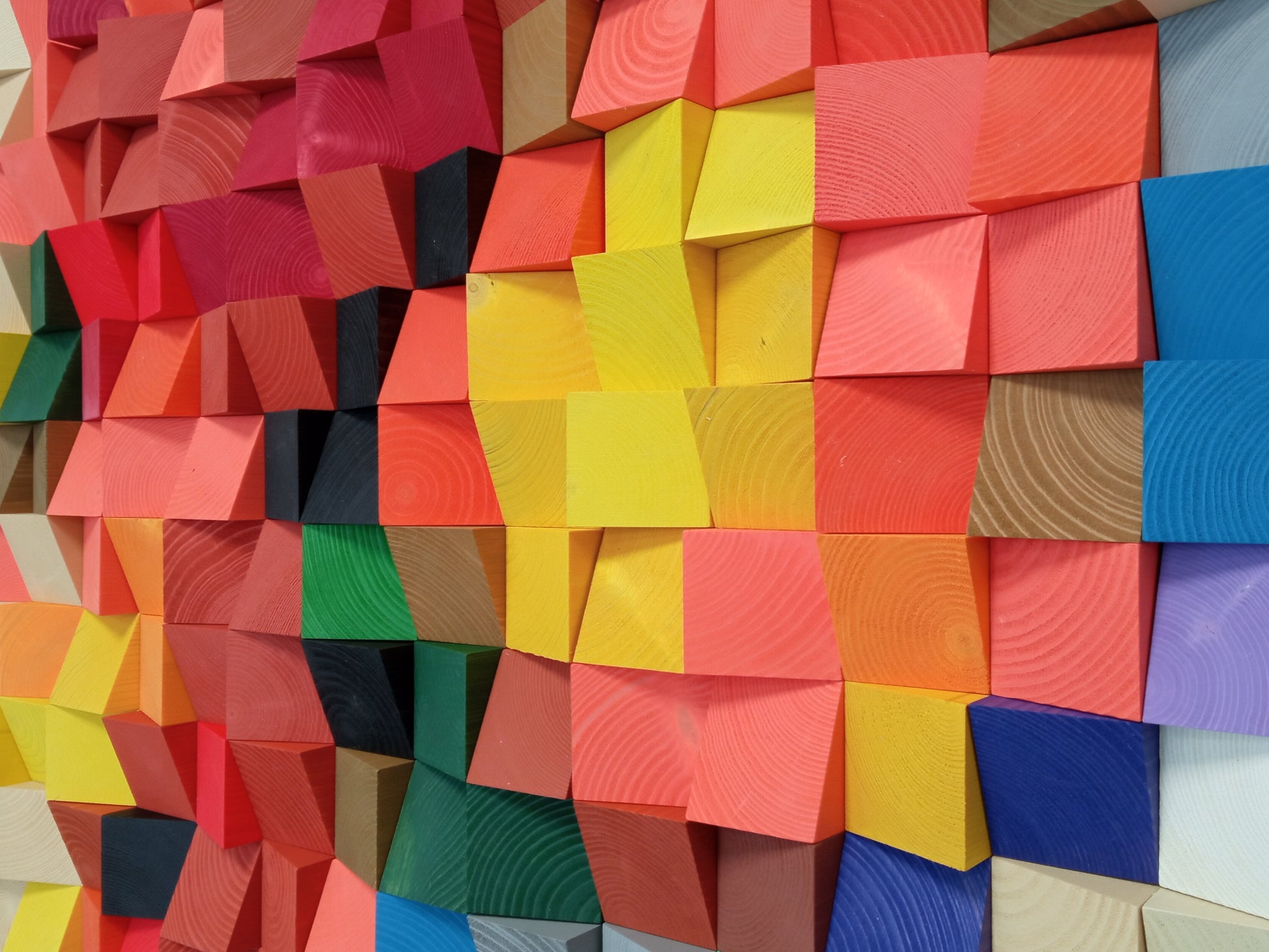 Multicolor acoustic panel crafted from wood blocks, offering both artistic depth and echo control.