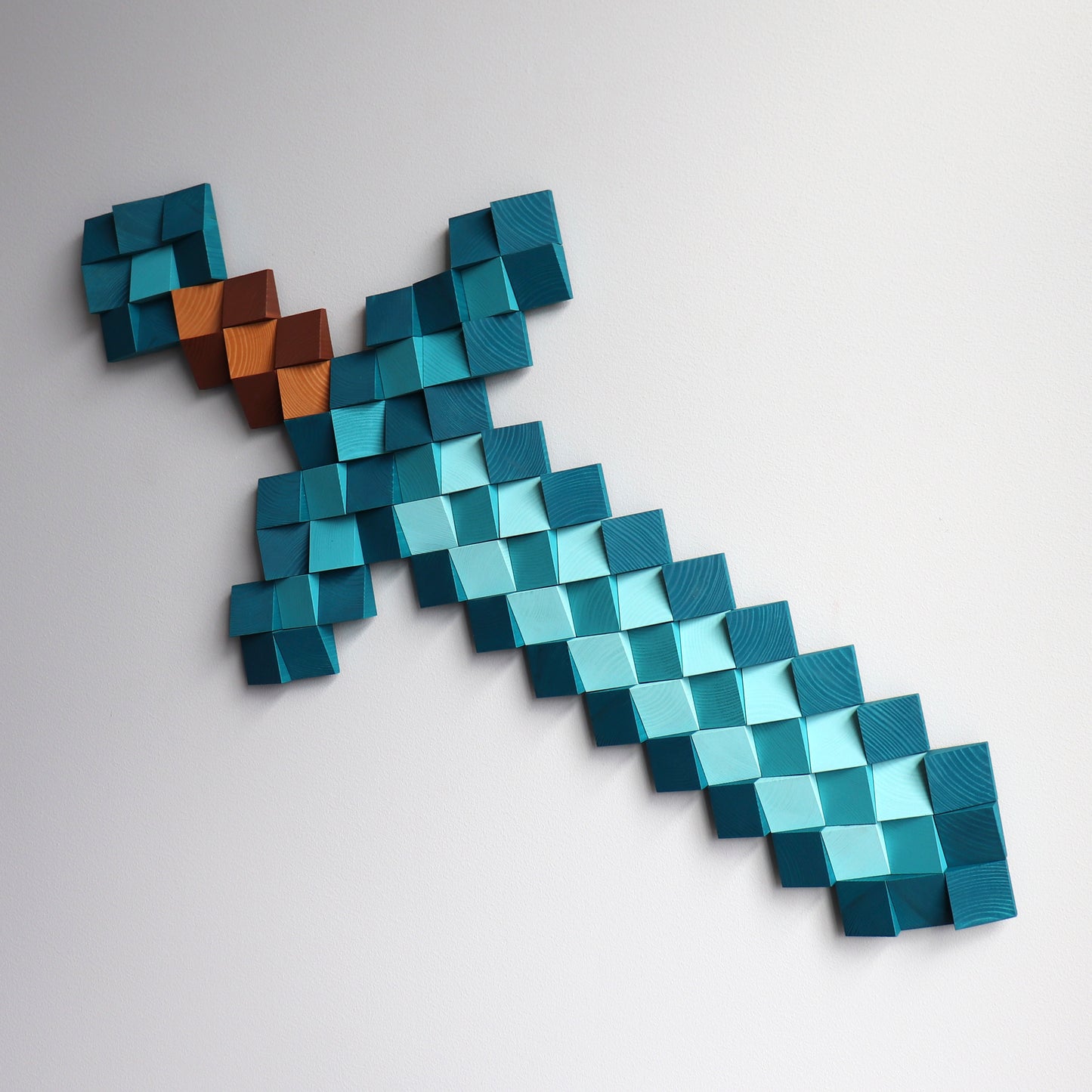 Handmade wooden Minecraft diamond sword wall art built from layered pixel-style wood blocks