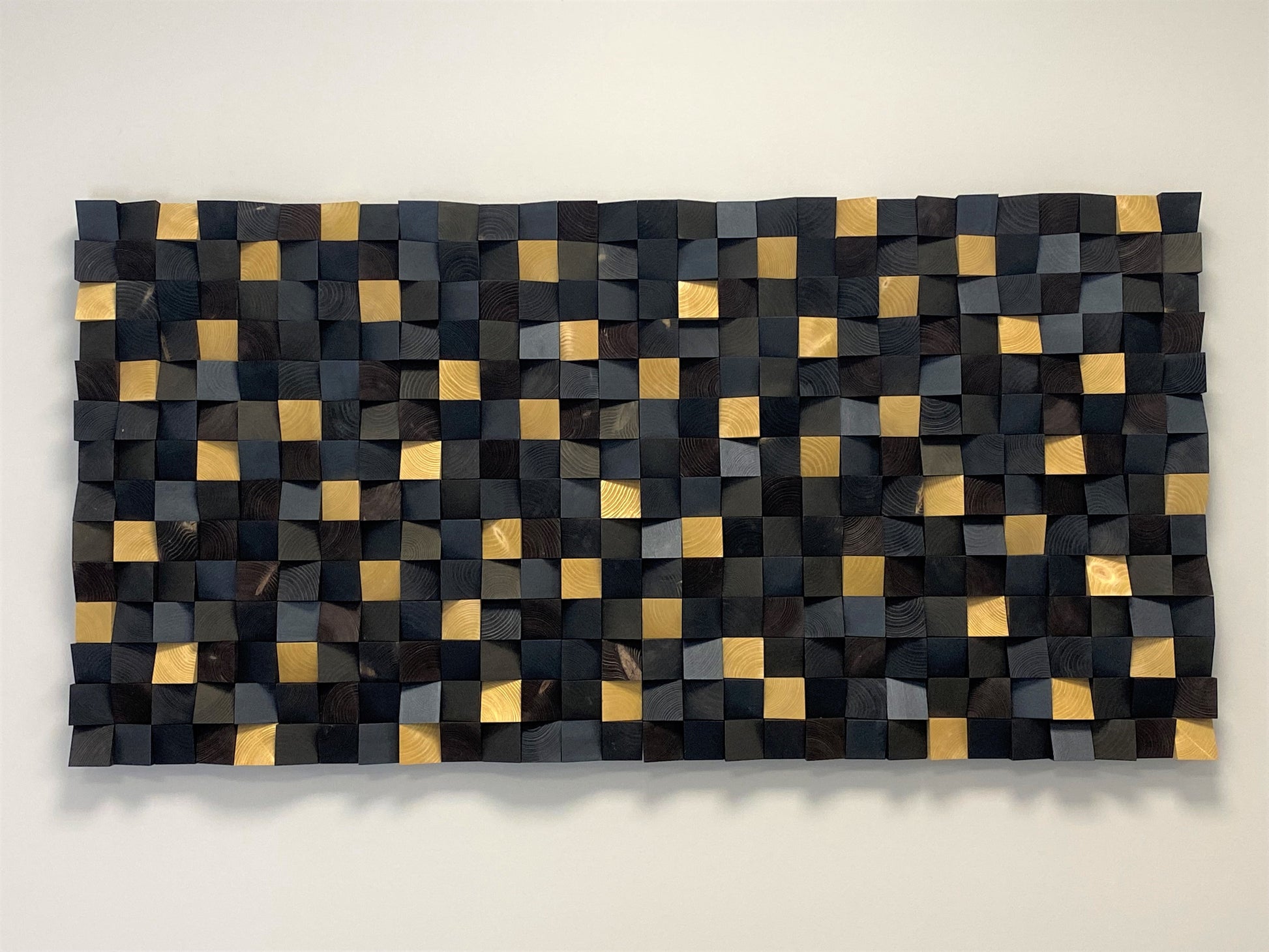 Modern black and gold 3D wall art adding texture and depth to contemporary interiors.