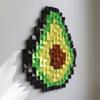 Modern avocado wall sculpture featuring layered green and yellow wooden pieces with a brown center.