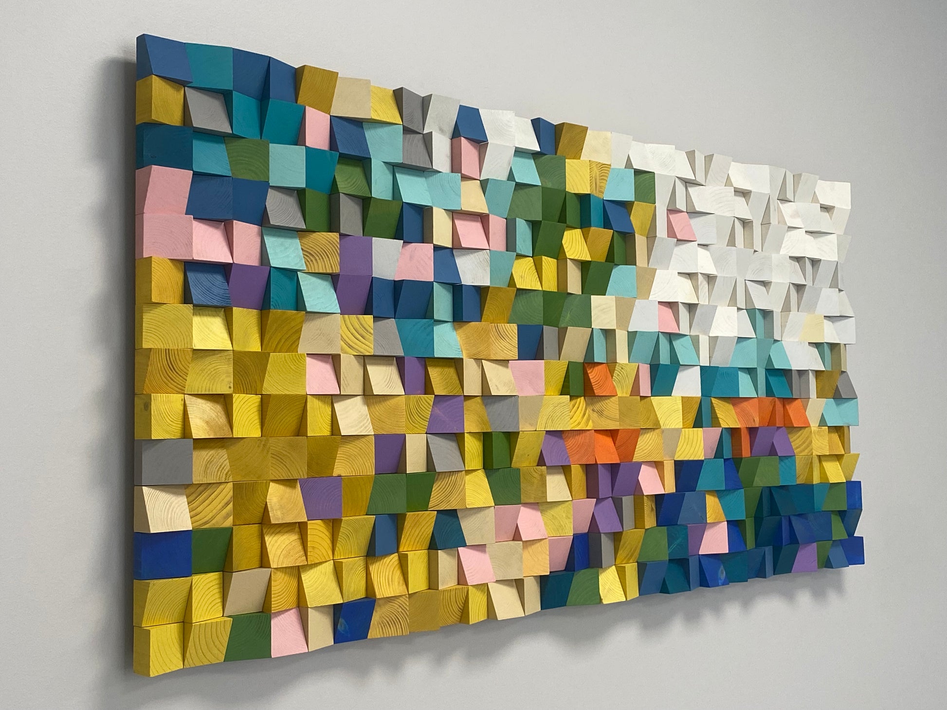 Modern rainbow-inspired wooden mosaic art made from sculpted wood.