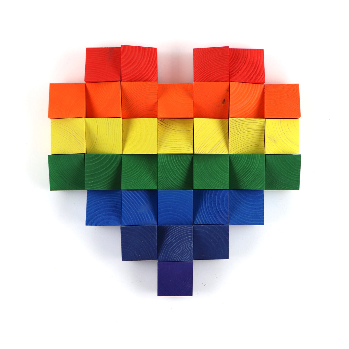 Rainbow pixel heart wall art made from layered wooden cubes arranged in a modern pattern