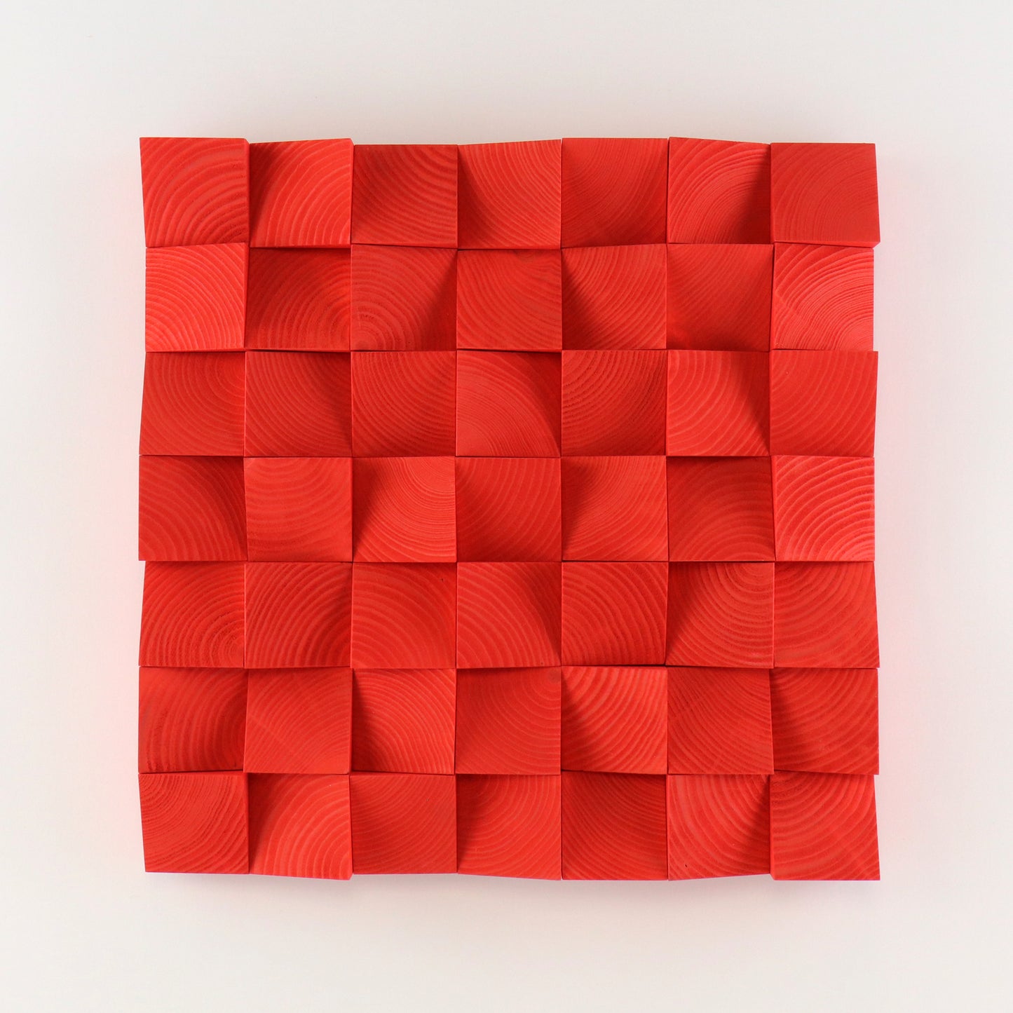 Vivid Pure Red wooden wall panel featuring hand-shaped 3D blocks arranged in a geometric grid, creating bold texture and a modern sculptural look.