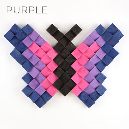 Purple and pink wooden butterfly wall art panel featuring layered geometric wood pieces.