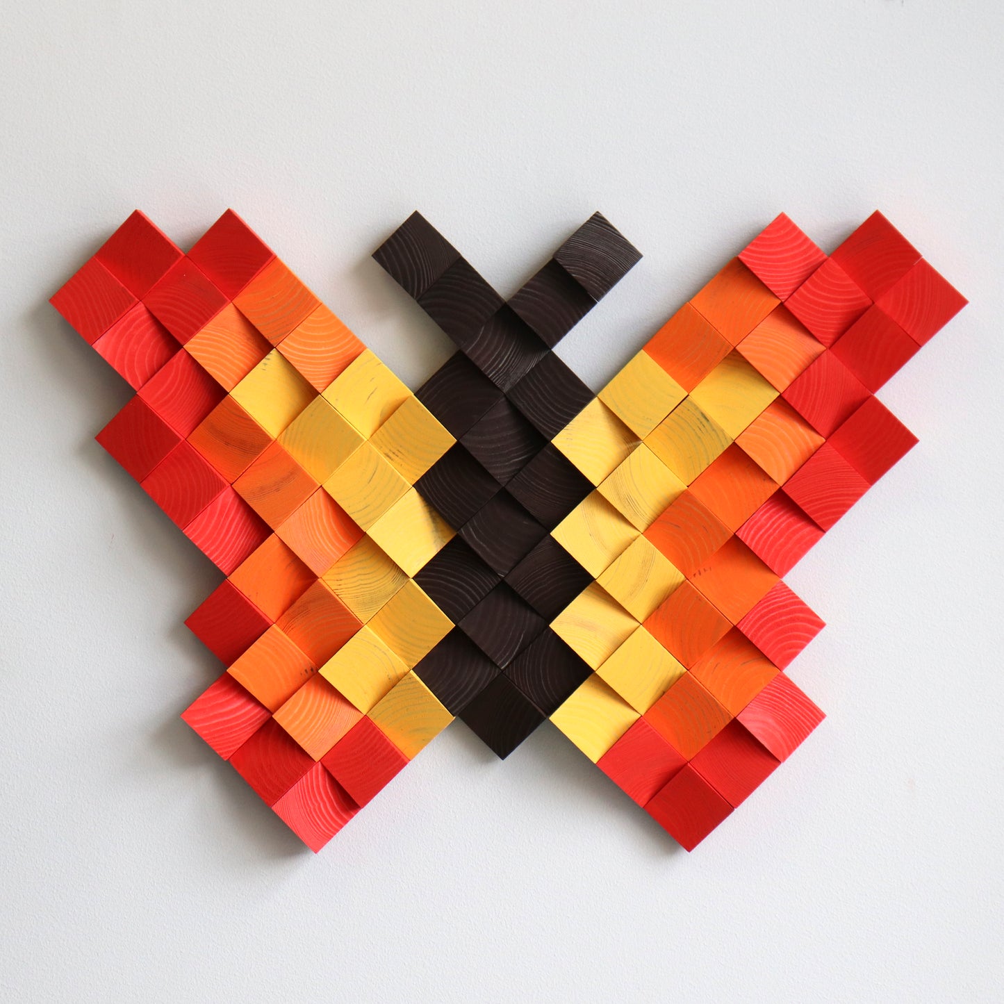 Red and orange wooden butterfly artwork designed with multilevel carved wood blocks.
