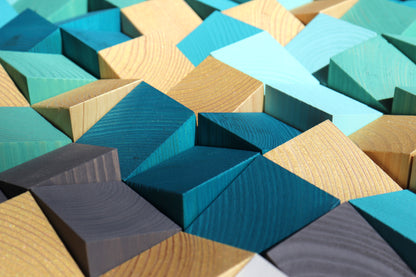 Handcrafted wooden wall art panel in ocean hues blending blue, gold, and gray for natural balance.