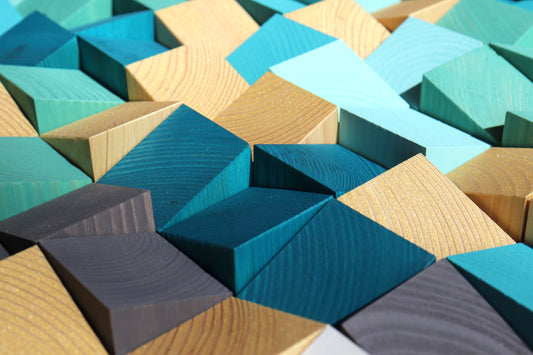 Handcrafted wooden wall art panel in ocean hues blending blue, gold, and gray for natural balance.