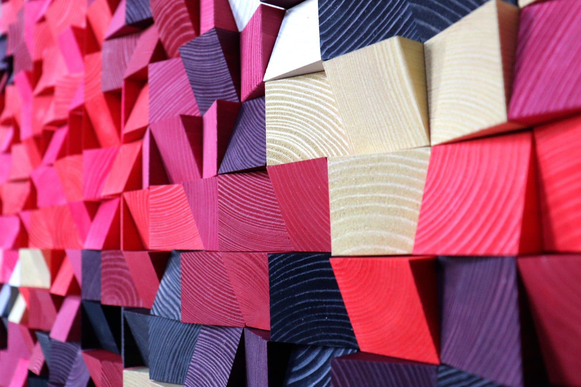 Handcrafted wooden wall art panel featuring vivid gradients of red and soft pastel shades.