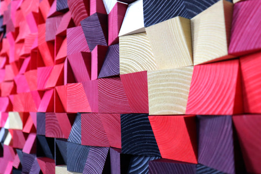 Handcrafted wooden wall art panel featuring vivid gradients of red and soft pastel shades.
