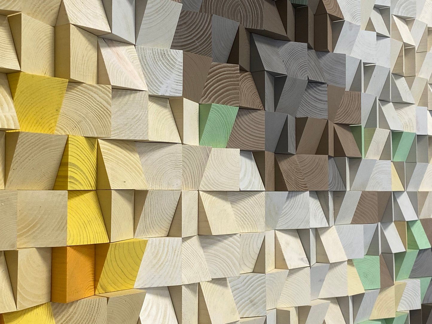 Detailed wooden block artwork blending warm sunlight with icy mountain-inspired colors.