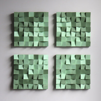 Green wooden art panel with sculpted 3D blocks and warm color palette.