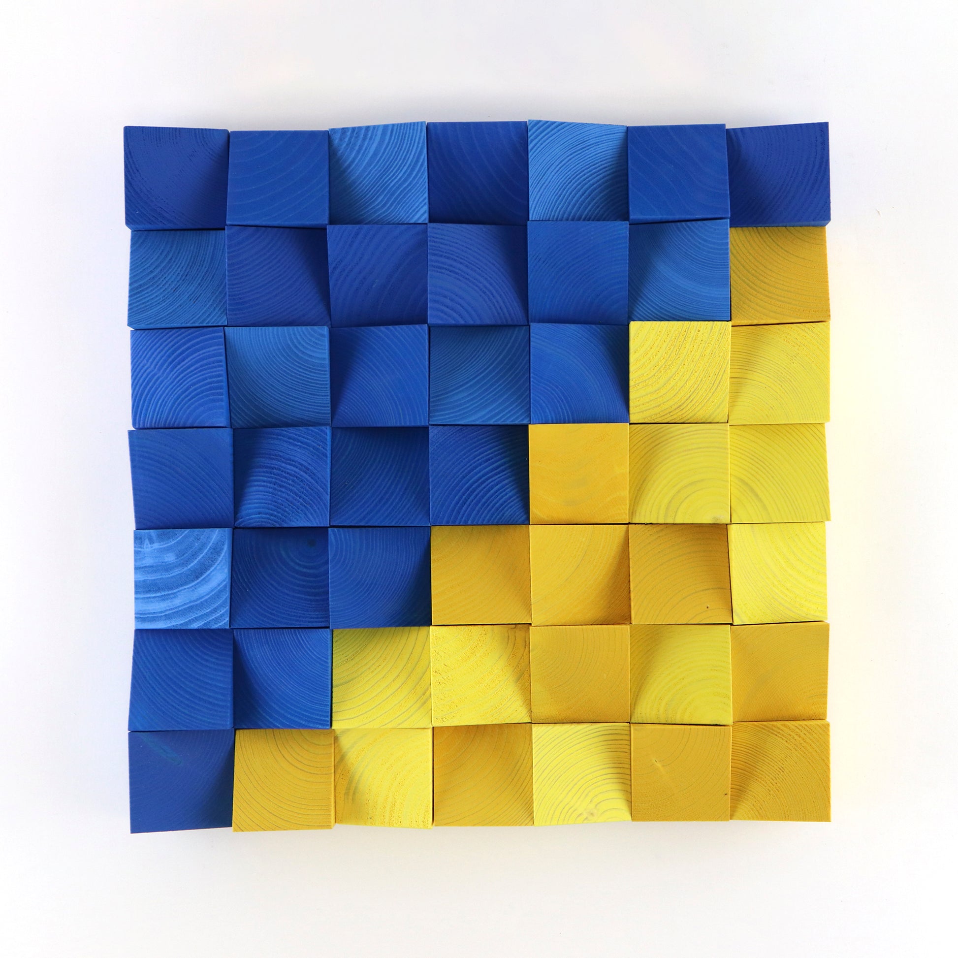 3D wooden wall art panel in blue and yellow tones inspired by the Ukrainian flag, handcrafted with geometric wood blocks.
