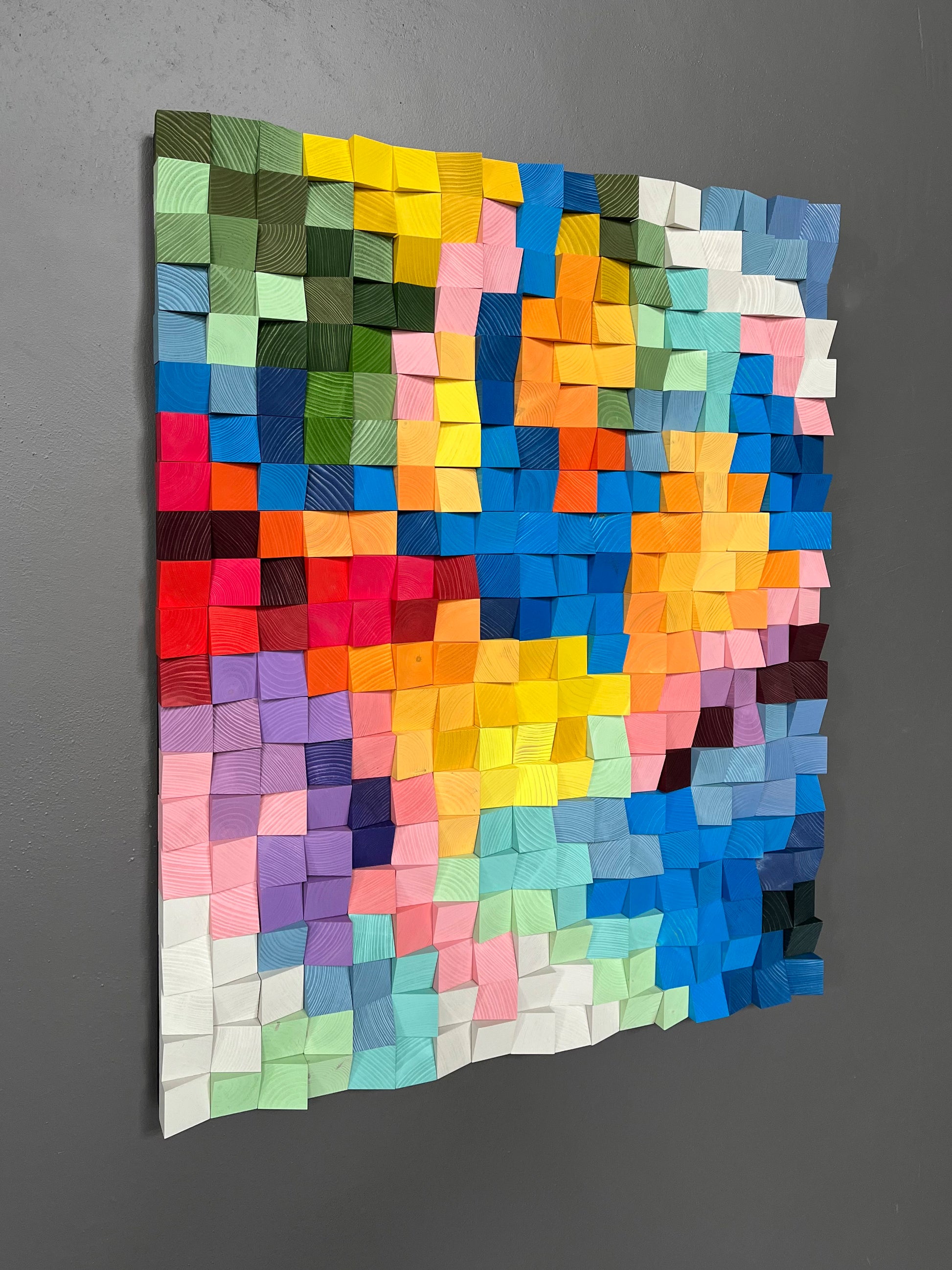 Vibrant handcrafted wooden wall decor with blue, pink, and yellow tones inspired by summer energy.