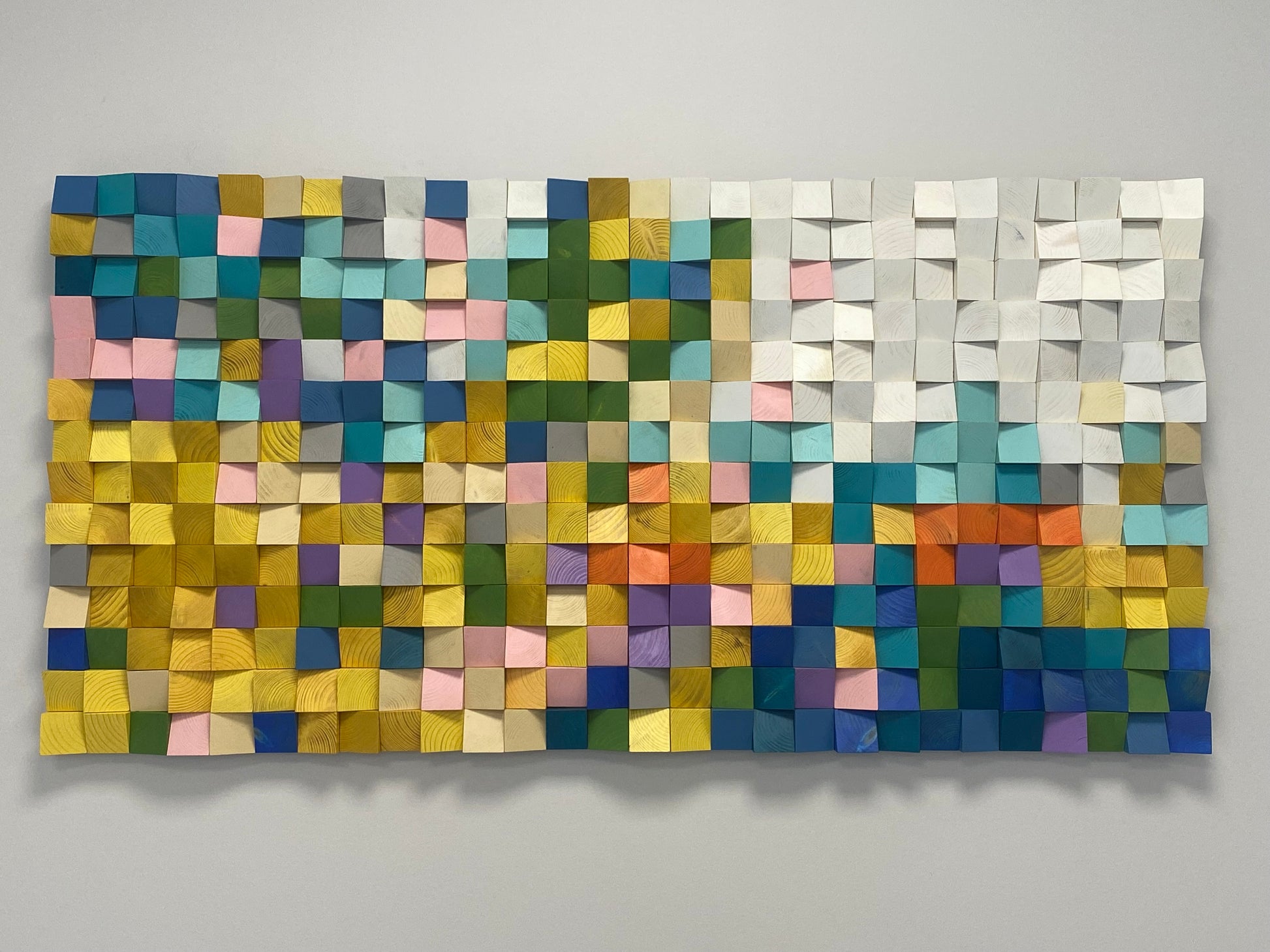 Vibrant multicolor wood mosaic artwork created with carved wood blocks.