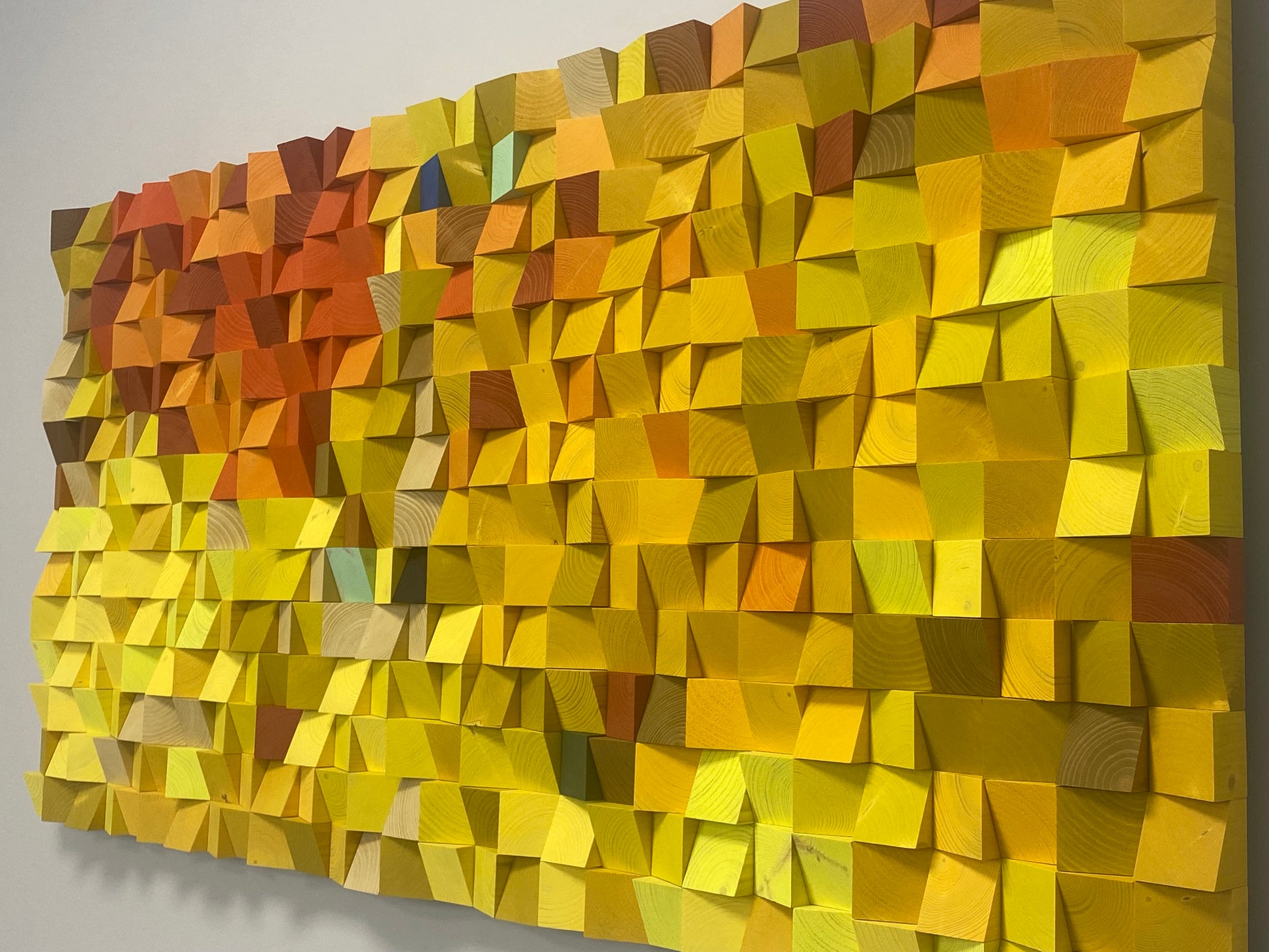 Vibrant wooden wall art sound panel with golden and amber tones, enhancing acoustic harmony and aesthetics.