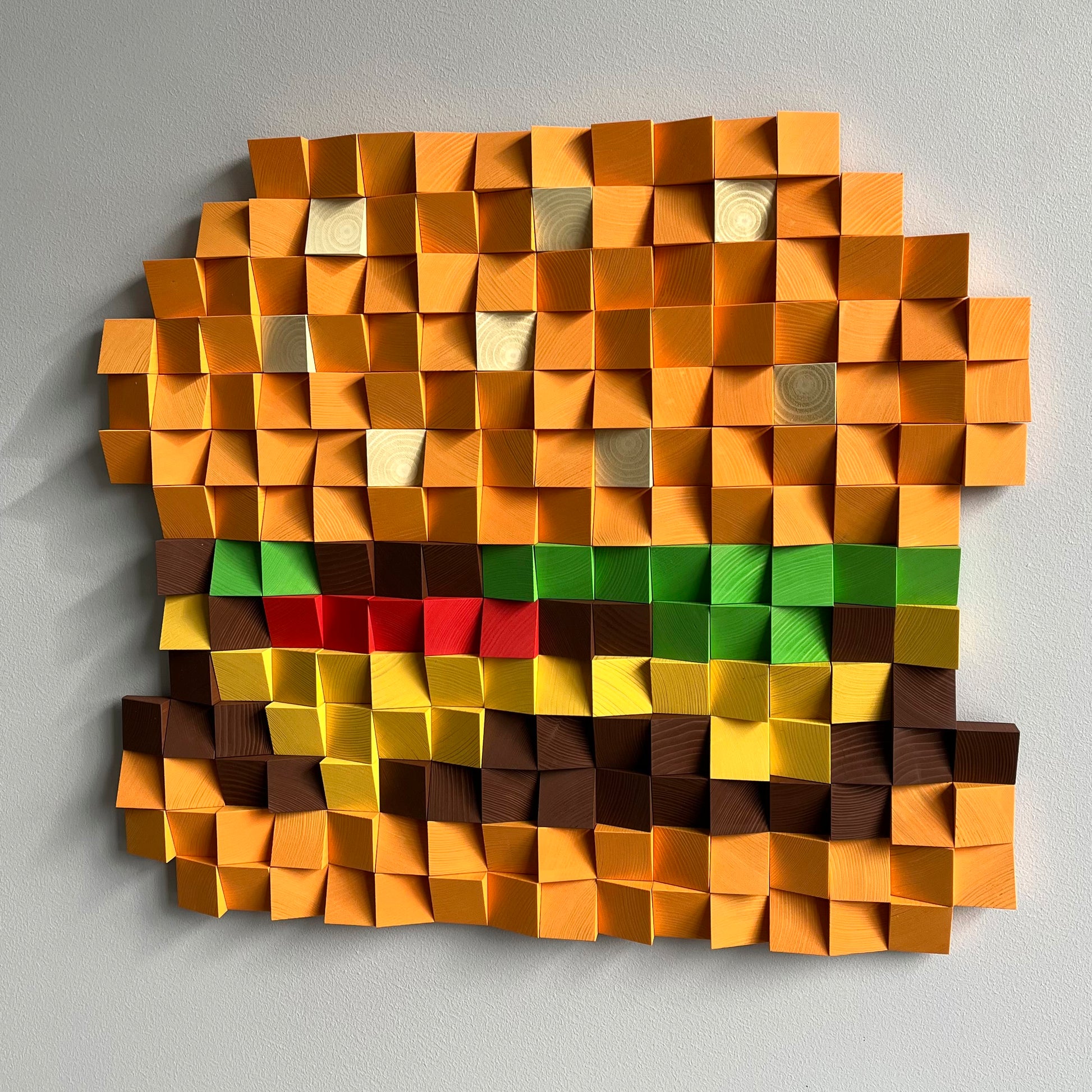 Cheeseburger wall art created from individual wood blocks with vibrant food-inspired colors