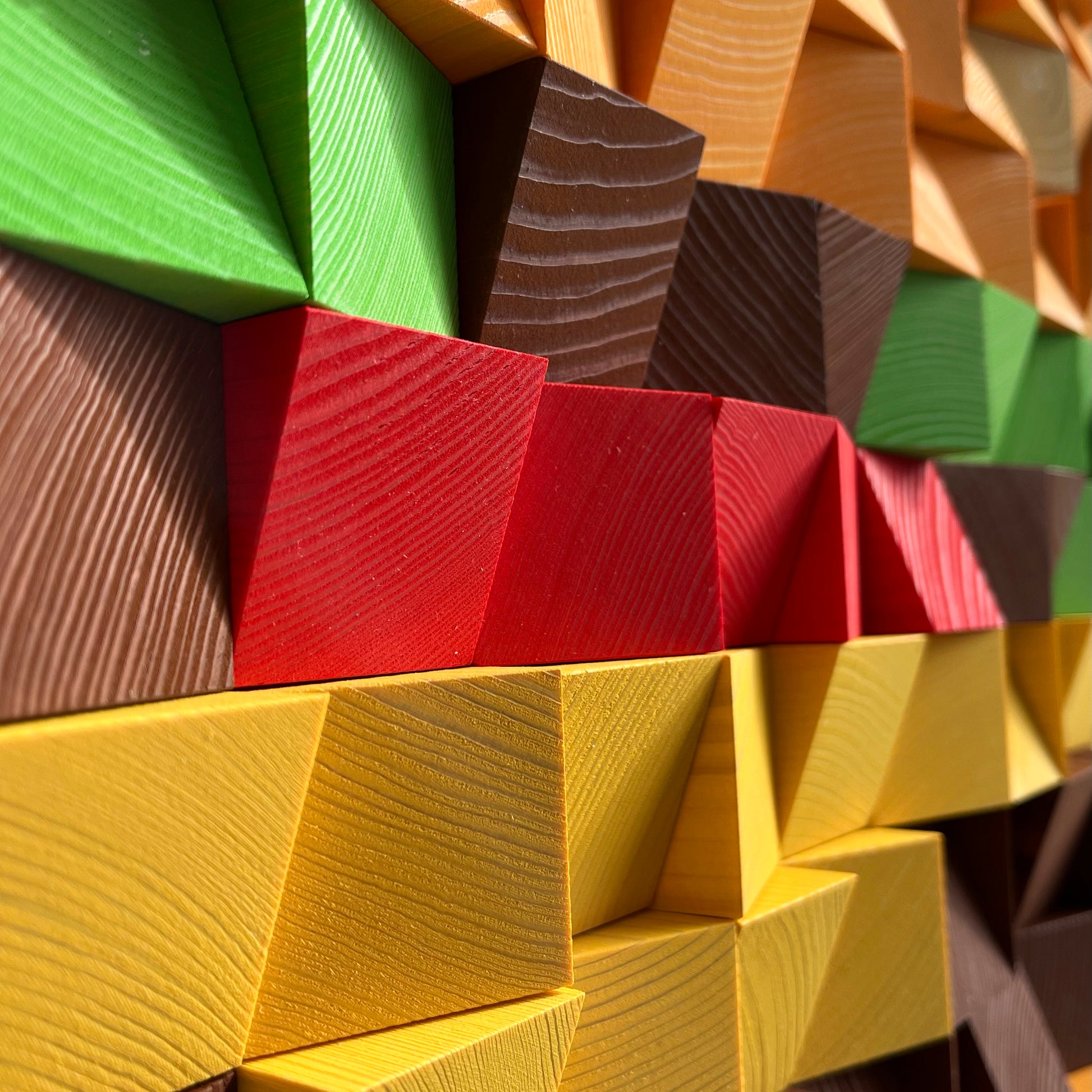 Modern cheeseburger wall decor crafted from painted wooden blocks with sculptural depth