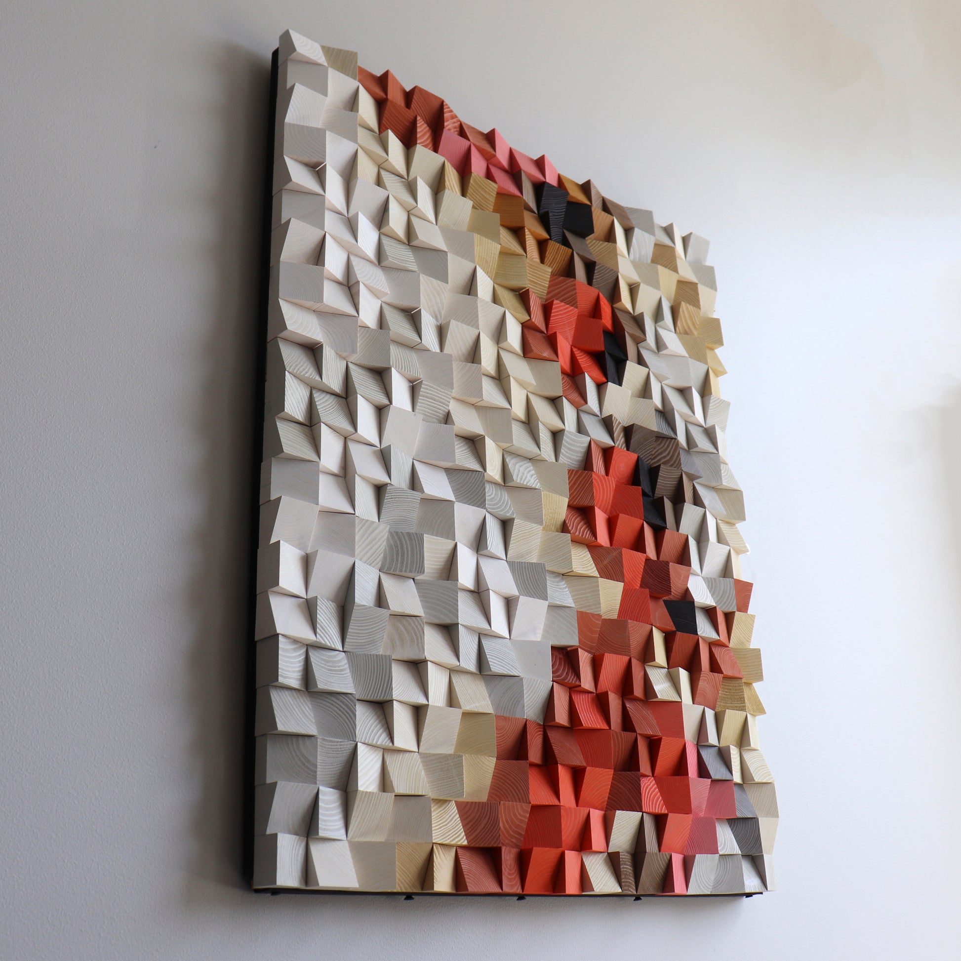 Artistic wooden wall piece with natural and coral red accents